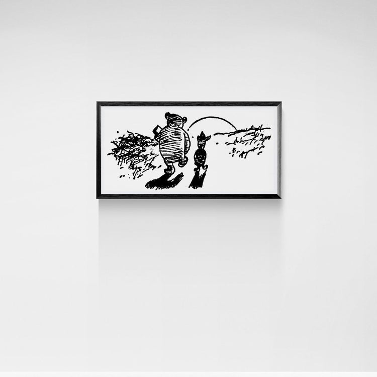 Framed black and white illustration of a bear and a piglet on a white wall