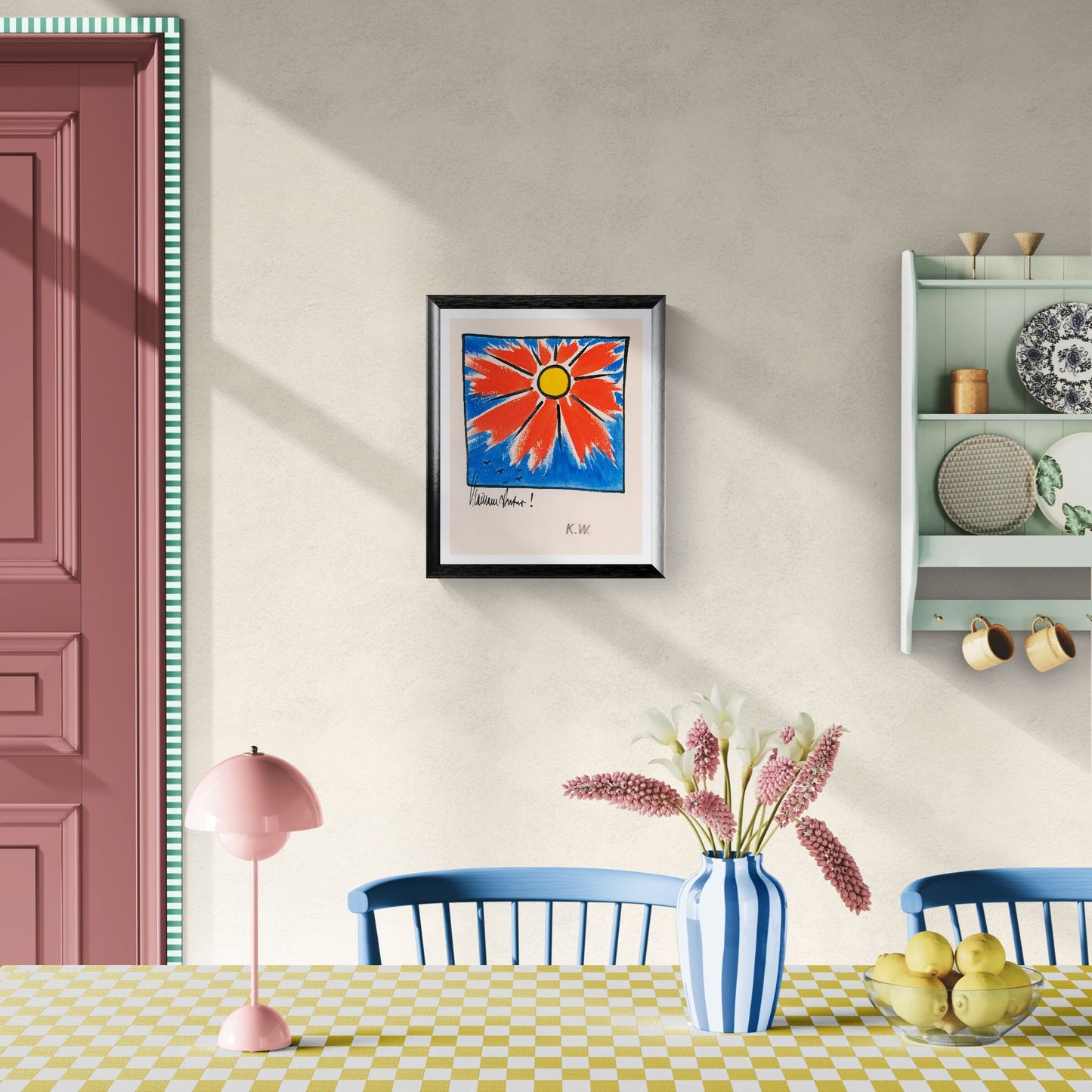 Dining room with a colorful abstract painting on the wall, pink lamp, and checkered tablecloth.