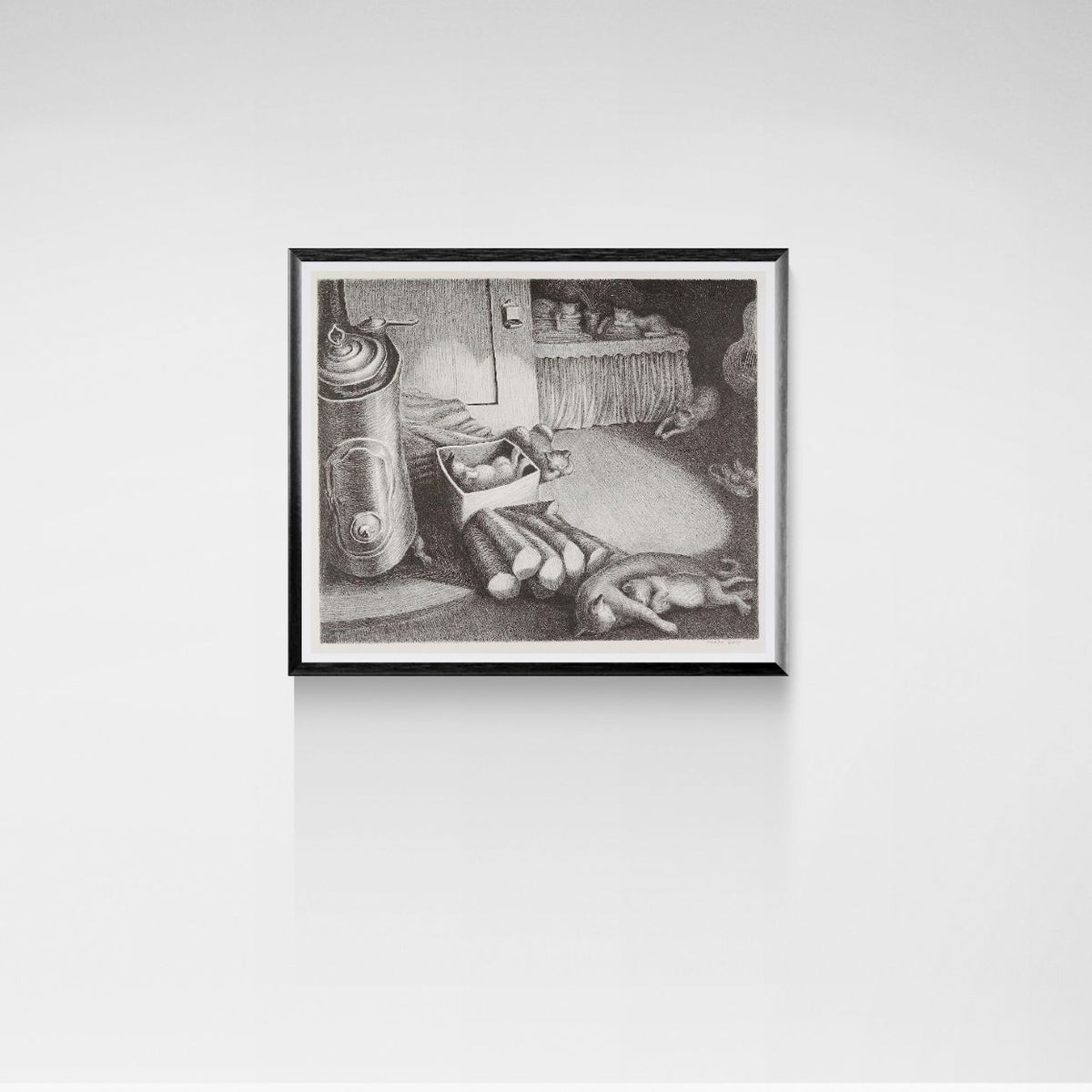 Framed black and white sleeping cats artwork on a white wall