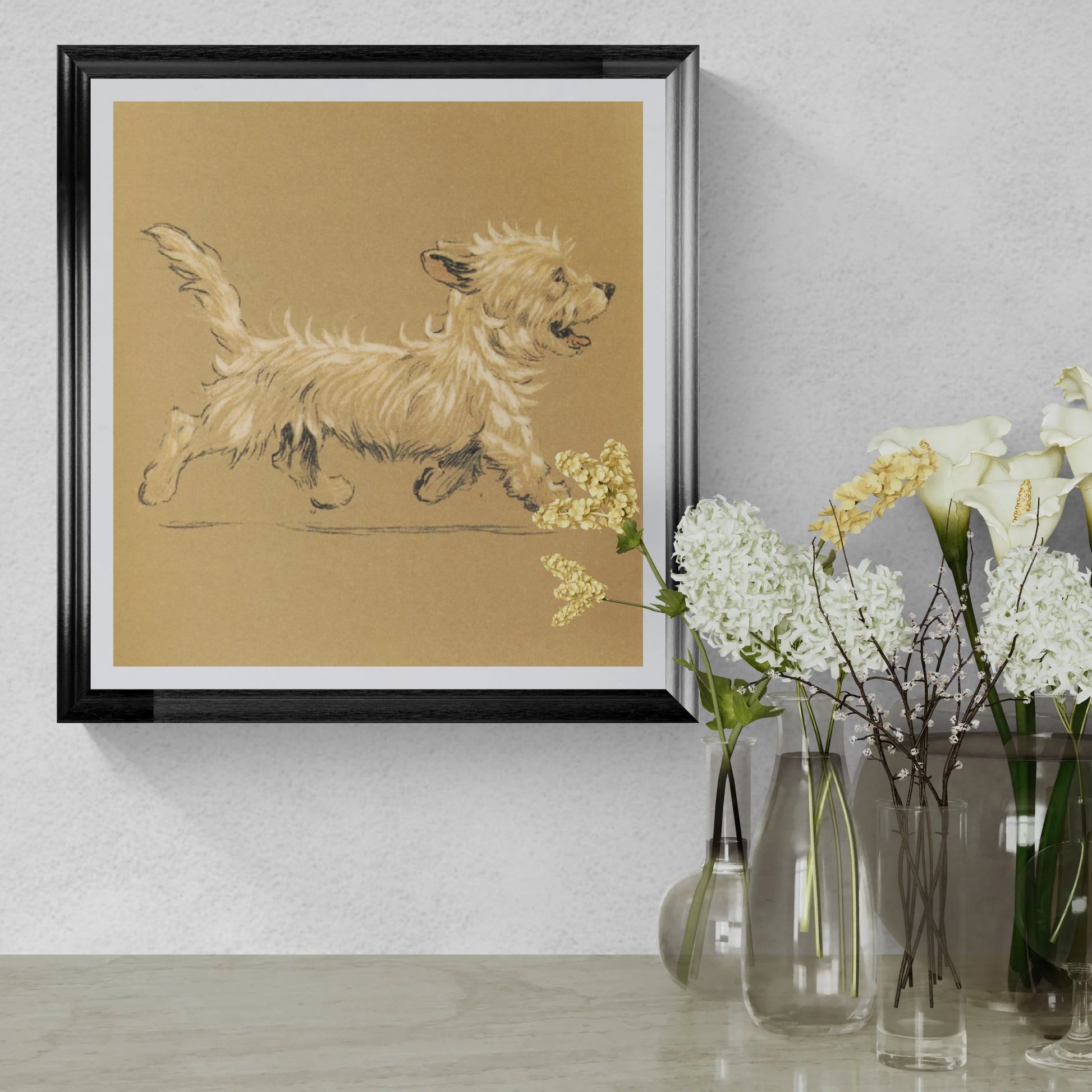 Framed artwork of a dog on a beige background, displayed on a wall with decorative vases and flowers.