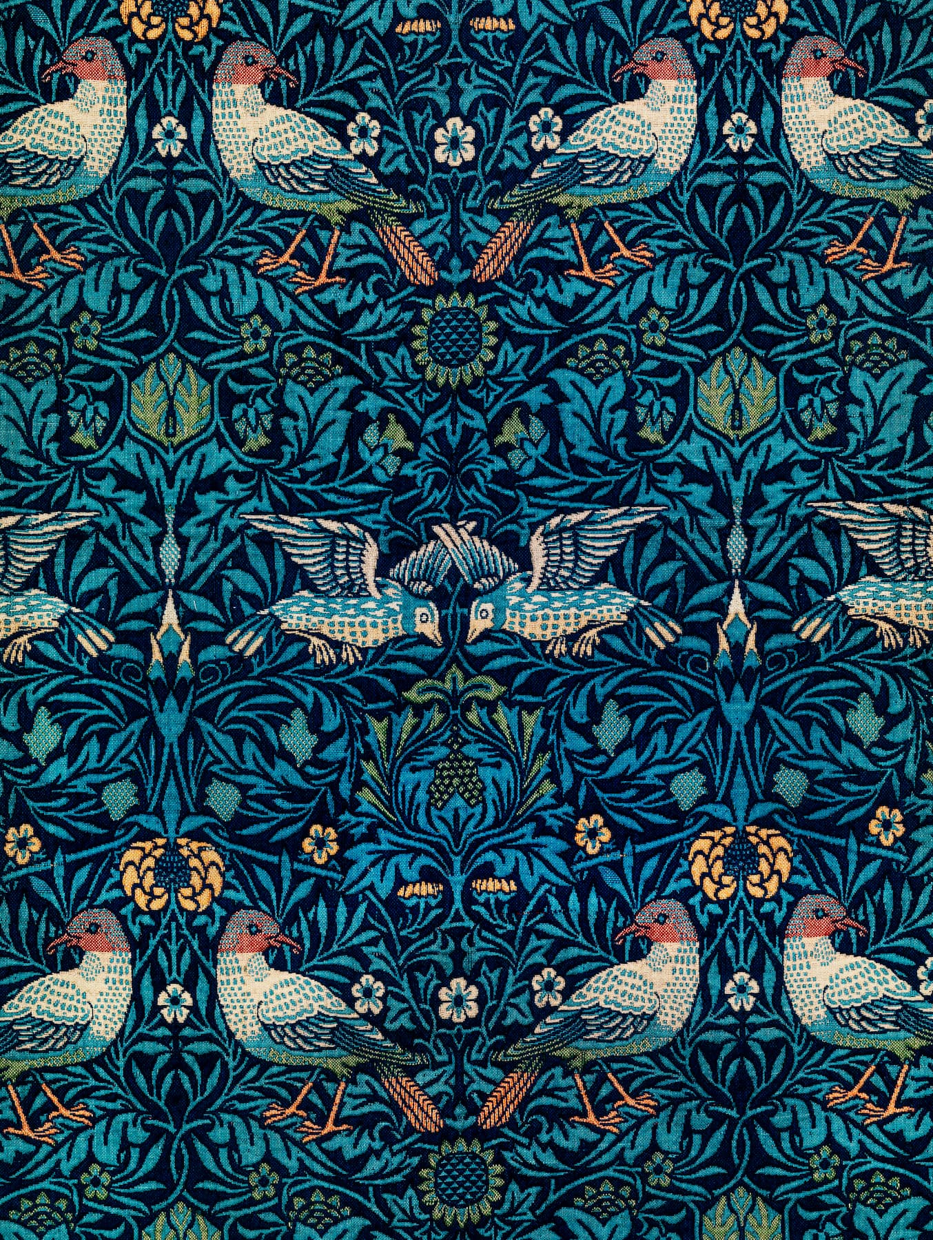 Patterned fabric with birds and floral designs on a blue background