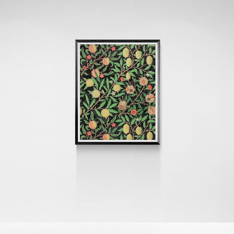 A framed botanical art print featuring a repeating pattern of green leaves, yellow peaches, and small red berries on a dark background, displayed against a clean white wall.