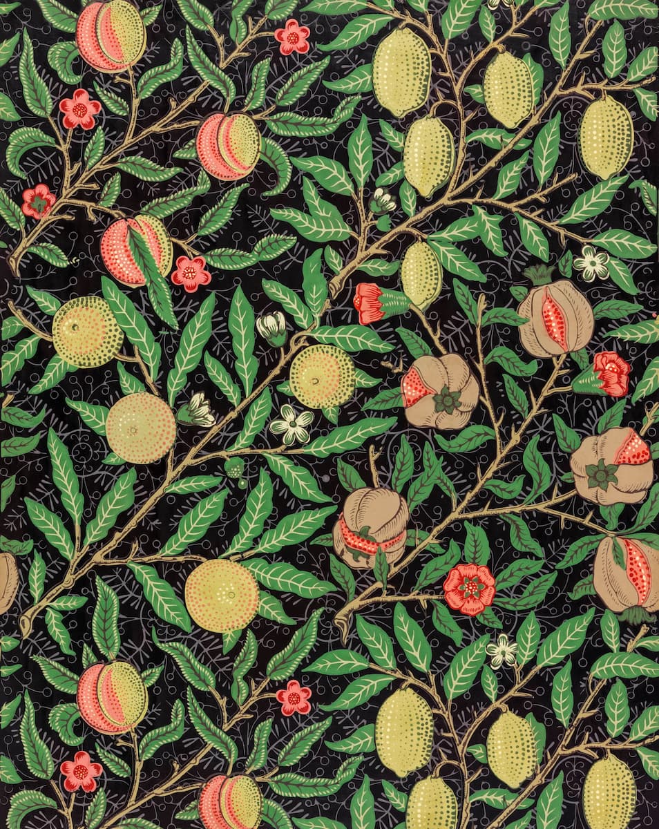 A repeating botanical pattern featuring green leaves, tan and yellow fruits, and small pink flowers on a black background.