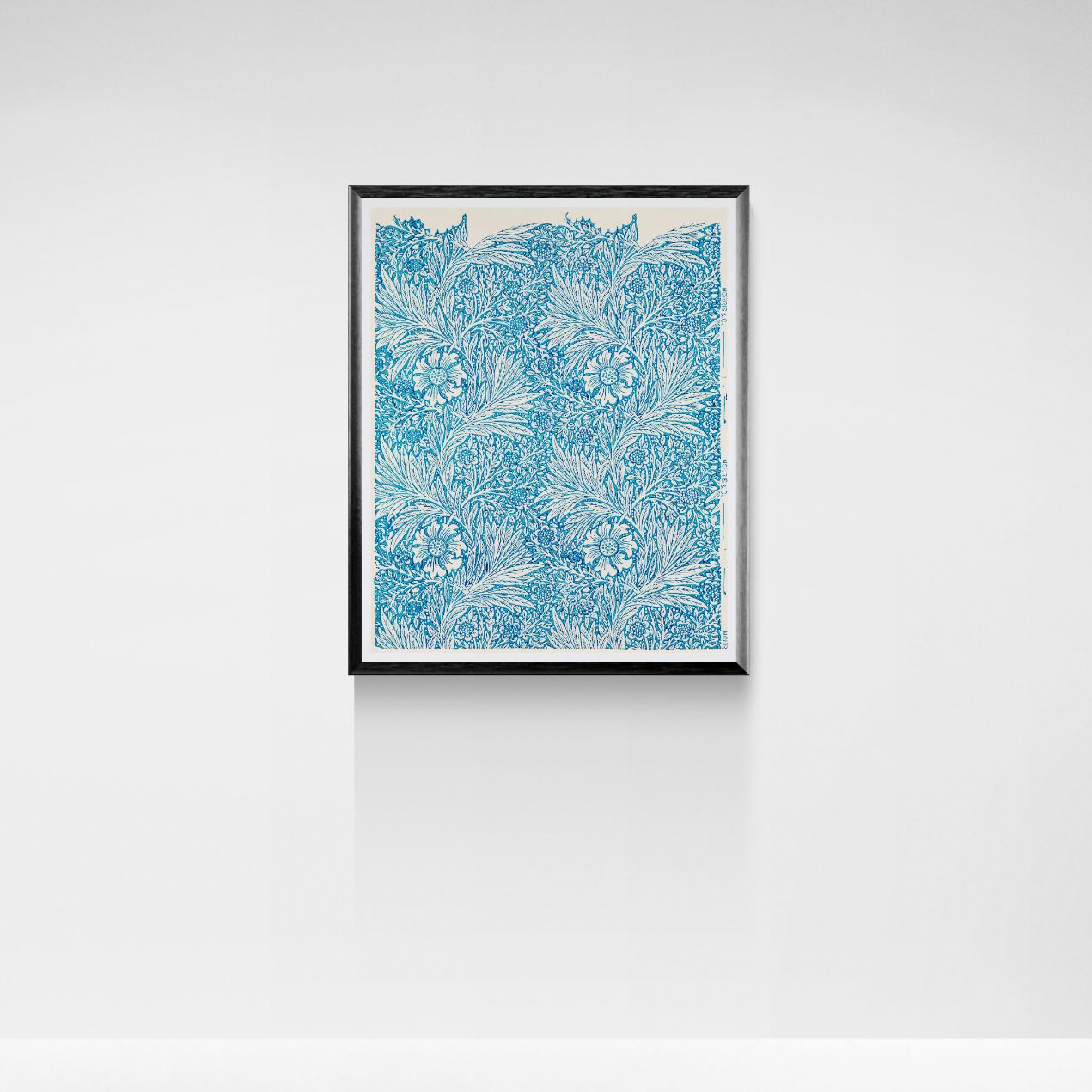 Framed artwork with a blue floral pattern on a white wall