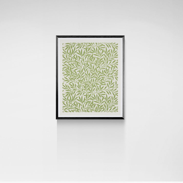 Framed artwork with a green leaf pattern on a white wall