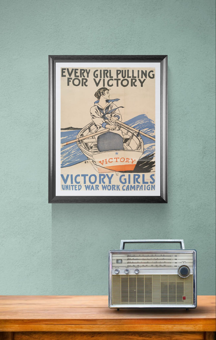 Framed vintage poster on a wall with a radio below